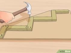 someone using an hammer to cut wood with a naildriver on the bottom step