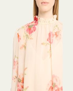 Zimmermann "Lightburst" cottonsilk blouse featuring a floral print     Ruffle stand collar    Long sleeves with ruffle cuffs     Blouson fit    Hem falls to the hip    Pullover style    Cotton/silk    Unlined    Dry clean    Imported Silk Floral Print Blouse For Daywear, Feminine Floral Print Blouse For Daywear, Spring Silk Blouse, Flowy Silk Blouse For Spring, Spring Blouse With Blouson Sleeves And Ruffled Collar, Feminine Blouse With Floral Print And Ruffled Collar, Evening Flats, Cocktail Jacket, Lingerie Sleepwear