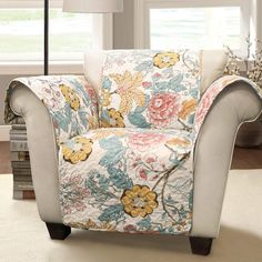 a living room scene with focus on the couch and chair covered in a floral fabric