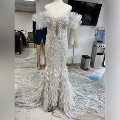 a mannequin is dressed up in white feathers