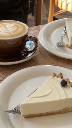 two plates with slices of cheesecake and a cup of cappuccino coffee