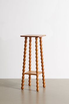 a small wooden stool sitting on top of a floor