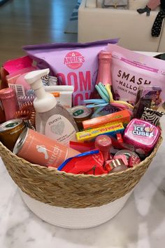 a basket filled with personal care items on top of a white marble counter next to a chair