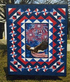 an eagle and american flag quilt with fireworks in the sky above it on a blue background