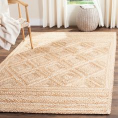 an area rug with a chair and window in the background