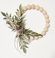 a wooden beaded bracelet with pine cones and flowers