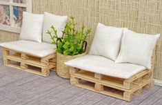 two wooden benches made out of pallets with plants in them