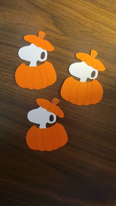 three pieces of paper cut out to look like pumpkins