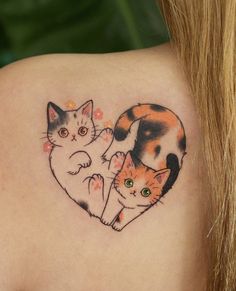 two cats in the shape of a heart tattoo on the back of a woman's shoulder