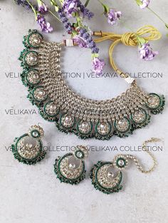 This beautiful emerald green bridal set consists of a statement necklace, earrings and maang tikka. Necklace plating is antique gold. Sparkling champagne stones with superior craftsmanship. Perfect for Indian and Pakistani weddings. Product Details: * Necklace -  Comes with adjustable zari cord.  * Earrings - For pierced ears. Length: 6 cm, Width: 4.5 cm approx * Maang Tikka Buy bridal bangles, chuda / choora and kalira here: https://www.etsy.com/ca/shop/VelikayaCollection?section_id=32318583 https://www.etsy.com/ca/shop/VelikayaCollection?section_id=36242466 Check out our collection of nose-rings, pasa, haathphool and hair accessories: https://www.etsy.com/ca/shop/VelikayaCollection ----------- CARE ----------- - Store in air tight zip lock bags - Do not expose to moisture/water - Do not Green Hand Set Chandbalis For Festivals, Green Hand Set Chandbalis For Diwali, Festival Green Hand Set Chandbalis, Green Chandbalis For Diwali Reception, Green Chandbalis For Reception And Diwali, Green Bollywood Chandbalis For Reception, Green Chandbali Bridal Earrings For Reception, Green Kundan Chandbalis For Wedding, Green Kundan Chandbalis For Reception