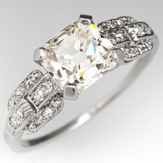 This stunning circa 1920s ring is centered with one (1) old mine cut diamond weighing 1.66 carats and set into a four-prong setting. The shoulders of the ring feature a pierced design and is accented with twelve (12), bead set, round single cut diamonds on each side. The ring measures 6.9mm at the top, rises 5.2mm above the finger, tapering to 1.0mm wide and 0.8mm thick at the base of the shank. This ring is currently a size 7.5. One of the small accent diamonds has a chip but nothing noticeable 1910s Engagement Ring, Black Gold Ring, Antique Diamond Rings, Diamond Engagement Rings Vintage, Engagement Ring Diamond Cut, Antique Engagement, Amethyst Jewelry, Vintage Engagement, Antique Engagement Rings