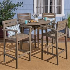 an outdoor table with four chairs around it