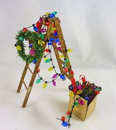 a wooden easel with christmas lights on it