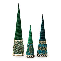 three green cones with designs on them sitting next to each other in front of a white background