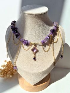 Indulge in the delicate charm of this handmade jewelry set featuring natural amethyst. The necklace, measuring 38 cm with a 5 cm extension chain, is adorned with stunning amethyst stones and 18K gold-plated clover-shaped pendants embellished with sparkling zirconia. The set includes transformer earrings with four detachable pendants, each 6 cm long, offering versatile styling options. The necklace features graceful cascading chains for an elegant, feminine touch. Perfect for any occasion, this s Amethyst Jewelry Set, Handmade Jewelry Set, Jewelry Sets Handmade, Amethyst Stones, Elegant Feminine, Clover Earrings, Natural Stone Jewelry, Amethyst Jewelry, Amethyst Stone