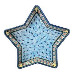 a blue star shaped dish with gold accents