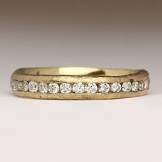 This is our take on a classic eternity ring – handmade and sand cast in 9ct yellow gold, with 2mm diamonds channel set half way around the ring. It has a lovely, tactile feel, and was made by casting recycled gold in a small mould using Cornish sand. The yellow gold has a soft and natural colour which provides a beautiful backdrop and contrast against the bright sparkle of the diamonds. The sand mould creates the texture you can see on the ring.The diamonds are fully traced from their mine of or Yellow Gold Eternity Ring, Gold Eternity Ring, Eternity Ring Gold, Diamond Eternity Ring, Organic Jewelry, Wide Ring, Anniversary Jewelry, Eternity Ring Diamond, Dress Rings