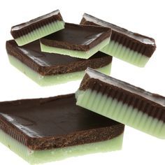 four pieces of chocolate cake with green frosting