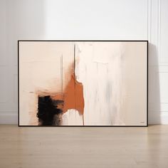 an abstract painting on the wall with white and black paint, in front of a wooden floor