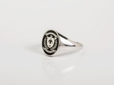 Coat of Arms jewelry - Family Crest Ring for Men ~ Customization included in purchase with your name or text on upper and lower ribbon, as preferred. Leave your note on chekcout. ✪ Classic Elegant design for men appearance with black enamel filling at face. ☛ Ring size as preferred, as it is custom created for you in our workshop. (select your ideal one in drop down menu) ☛ Custom design inside ring with your own personalized logo / pattern / symbol is possible. Contact us now! ❏ Material: ✪ Rin Classic Enamel Ring Gift, Classic Enamel Ring As Gift, Classic Round Enamel Ring With Polished Finish, Classic Oval Hallmarked Enamel Ring, Classic Formal Enamel Ring, Classic Oval Enamel Ring For Gift, Classic White Gold Enamel Ring, Classic Oval Engraved Ring For Commemoration, Formal Oval Hallmarked Enamel Ring