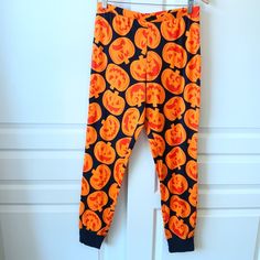 New Without Tags. Black Cotton Joggers With All Over Orange Jack-O-Lantern Print. Elastic Waist And Ribbed Cuffs. 100% Cotton Machine Wash Cold On Gentle And Tumble Dry Low. Size Large Waist: 15.5" Hip: 20" Rise: 11.5" Inseam: 30" Measurements Are Approximate. No Trades. No Modeling. Orange Long Sleeve Sleepwear For Fall, Casual Orange Sleepwear For Fall, Orange Sleepwear For Halloween, Fall Sleepwear With Elastic Waistband And Long Pants, Orange Pants For Fall Loungewear, Long Pants Sleepwear With Elastic Waistband For Fall, Long Pants Sleepwear For Fall, Casual Halloween Orange Sleepwear, Orange Bottoms With Elastic Waistband For Loungewear