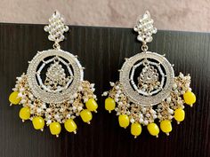 Yellow Jhumka Kundan Earrings. Handcrafted pair of earrings. Gives a traditional look. Can be worn for engagement and wedding parties. Indulge in it or gift it and watch the compliments flow! It is advisable to store jewelry in a zip lock pouch (air tight pouch), keep away from water perfume and other chemicals and clean it with soft cloth. FREE SHIPPING!! Yellow Traditional Earrings, Yellow Earrings Indian, Yellow Jhumka, Punjabi Jhumka, Earrings Kundan, Saree Jewellery, Bridal Jewellery Design, Water Perfume, Store Jewelry