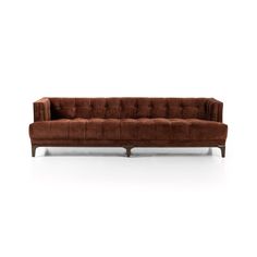 a brown couch sitting on top of a white floor