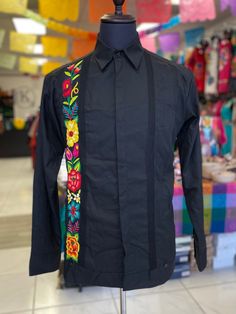 Flowers abound in Mexico, but nowhere are they as glorious as the brilliant blossoms embroidered on the festival outfits of women living in Oaxaca State in the Isthmus of Tehuantepec. The techniques used to embellish this Guayabera include hand embroidery, machine chain stitch, machine embroidery in hand-guided satin stitch, chain stitch worked with a crochet hook, and ribbon work. For centuries, Oaxaca has been recognized as a leader of a beautiful artistic production in the textile world. PLEA Male Mexican Outfit, Traditional Mexican Men Outfit, Charro Outfits For Women, Traditional Mexican Mens Clothing, Guayabera Outfit, Charro Outfit, Traditional Mexican Shirts, Men’s Guayabera Outfit, Formal Shirt Dress