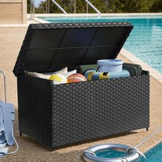 an outdoor storage box next to a swimming pool