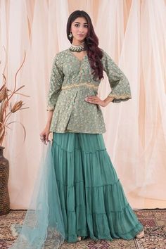 Aqua jade green peplum top with floral patterns, tasseled placket and placed pearl, cutdana, sequins and zari zardozi scalloped embroidery. Comes with tiered sharara and sequin spread dupatta. - Aza Fashions Designer Green Dress With Ruffles, Green Palazzo Set With Unstitched Blouse For Reception, Green Bollywood Sharara With Ruffles, Green Peplum Festive Dress, Festive Green Peplum Dress, Festive Ruffled Peplum Lehenga, Elegant Green Tops For Eid, Festive Peplum Sets With Ruffles, Traditional Green Ruffled Sharara