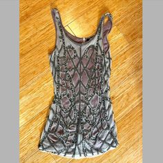 Stunning Anthropologie Sleeveless Top/Tank. Smoky Gray Cotton Underlayer With Intricate Beaded, Sequined And Mesh Overlay. This Is One Piece, With Both Layers Fully Attached Around Neck And Arm Openings. 1920s Feel. Zip Opening At Back Of Neck. This Piece Has A Really Nice Weight To It That Proves Its High Quality. No Tags, But Never Worn! Sleeveless Embellished Top For Evening, Embellished Sleeveless Top For Evening, Embellished Fitted Sleeveless Blouse, Sequined Silver Tank Top For Night Out, Fitted Silver Tank Top For Summer, Silver Sequined Tank Top For Night Out, Sequin Silver Tank Top For Night Out, Glamorous Embellished Summer Tank Top, Embellished Fitted Sleeveless Tank Top