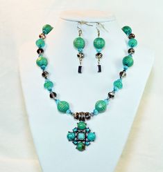 "This listing is for a ONE OF A KIND Necklace & matching earrings.... This is a beautiful turquoise blue / aqua necklace.  It features carved  wooden round beads, polished aqua glass rondelle beads, Swarovski bi-cone crystals, faceted chez crystal rondelle & faceted glass beads.  Pendant is imitation turquoise & rhinestone crystals mounted on base metal.   Made with a sterling silver lobster clasp, necklace is 17.25 inches in length.  Matching earrings are made on sterling silver sheppard hooks Turquoise Faceted Beads Costume Jewelry, Traditional Turquoise Jewelry With Faceted Beads, Aqua Necklace, Pink Beaded Bracelets, Necklace Matching, Aqua Beads, Aqua Glass, Beads Pendant, Rose Quartz Beads