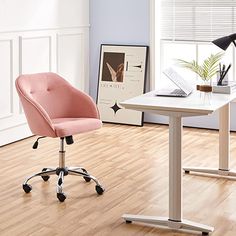 a pink chair sitting next to a white table on top of a hard wood floor