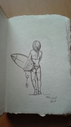 a drawing of a person holding a surfboard on top of a piece of paper