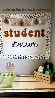 a bulletin board with the word student station on it next to two crates and boxes