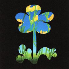 an image of a blue flower with yellow flowers on it's petals in the dark