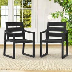 two black chairs sitting next to each other on a rug