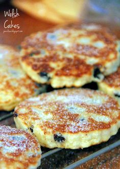 blueberry pancakes cooling on a rack with powdered sugar