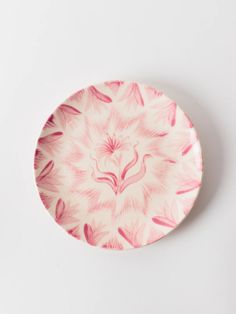 a pink and white plate sitting on top of a table