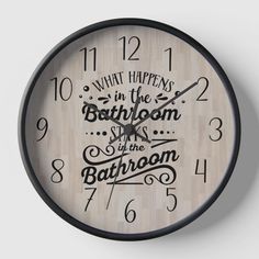 a clock with the words what happens in the bathroom is at the bathroom on it