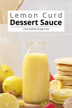 lemon curd dessert sauce in a glass jar surrounded by sliced lemons and strawberries