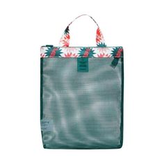 a green bag with red and white flowers on the front, sitting against a white background