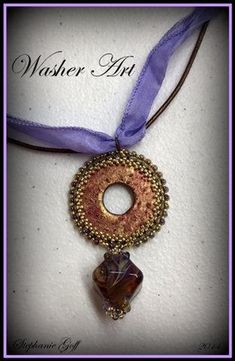 a necklace with a beaded circle on it and a purple ribbon around the neck