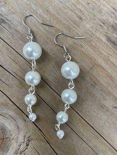 These earrings are made with white glass Pearl beads Pearl White Dangling Bead Earrings, Pearl White Dangle Earrings With Beads, Handmade White Dangle Clip-on Earrings, Handmade White Dangle Crystal Earrings, Handmade White Crystal Dangle Earrings, Pearl White Earrings With Dangling Beads, Adjustable Pearl White Dangle Earrings, White Dangle Pearl Earrings For Party, White Pearl Long Drop Earrings