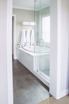 a bathroom with white towels hanging on the wall