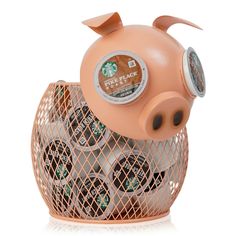 a pink piggy bank filled with lots of coffee beans in it's cage