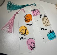 two tags with skulls and pumpkins on them