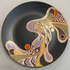 a black plate with an artistic design on it