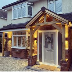 the front entrance to a house lit up at night