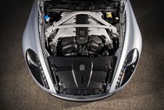 the engine compartment of a silver sports car